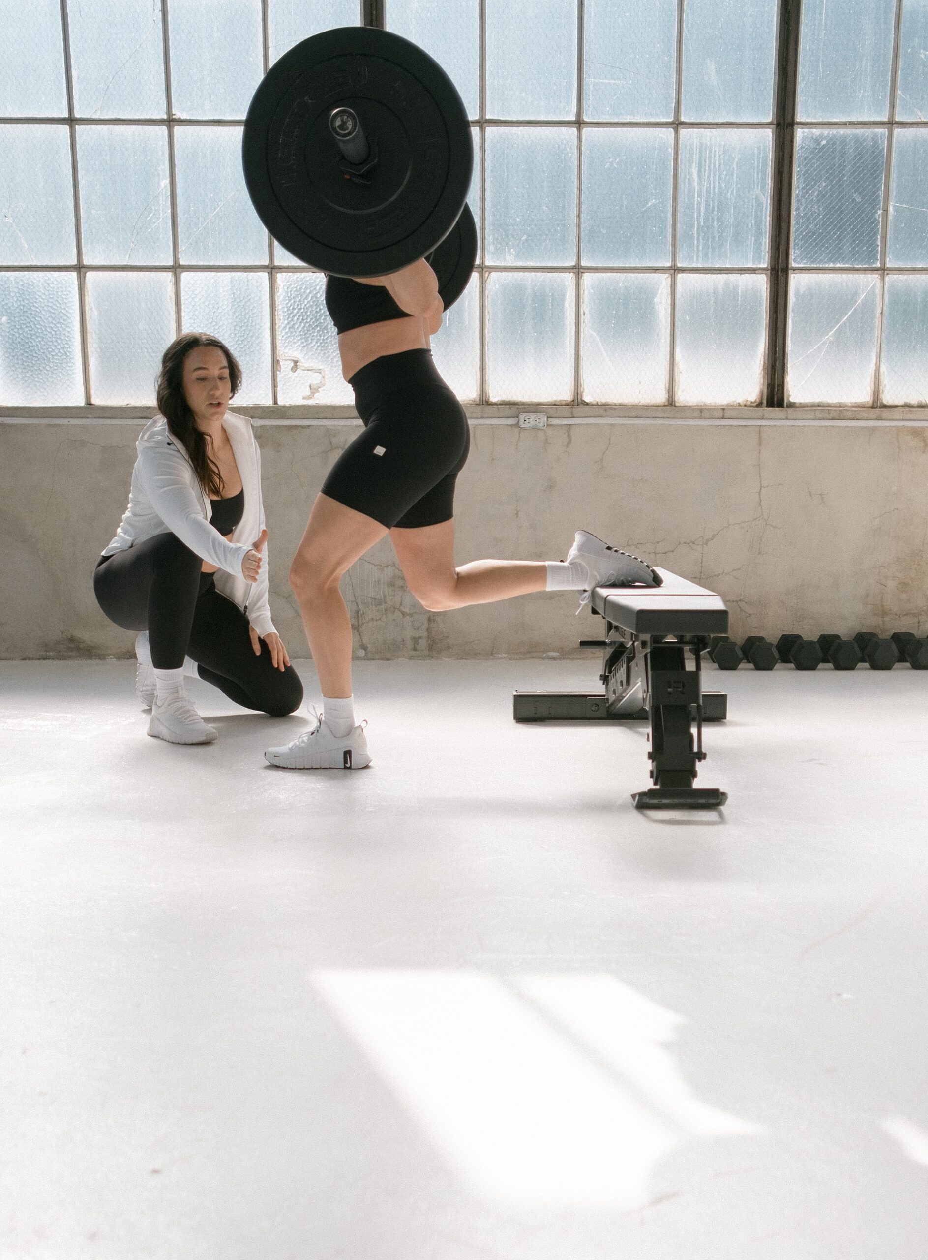 woman coaching someone while strength training | Why Your Workout Class Isn’t Gonna Cut It (If You Want Real Results)
