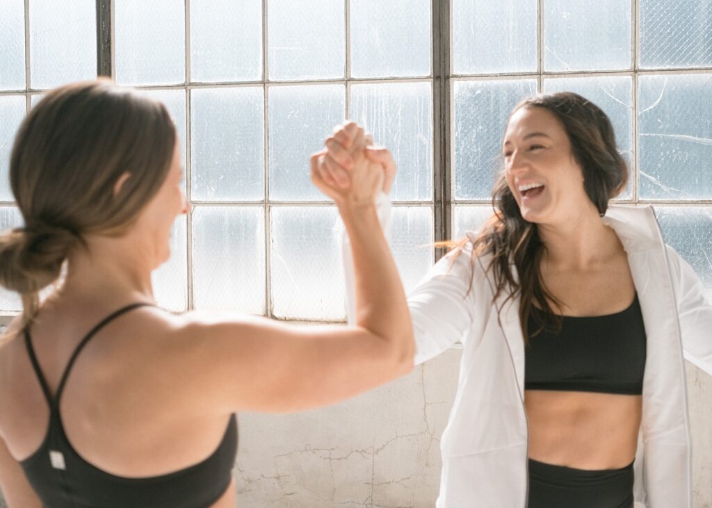 Coach encouraging client during workout | How Many Workouts Should I Do Per Week? 